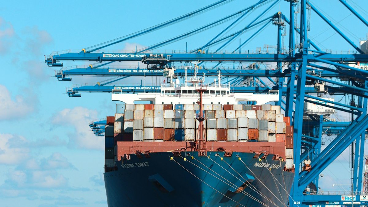 Docked container cargo ship at seaport terminal — OM Enterprise